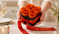 Orange preserved roses in a black rose box with personalised Happy Birthday satin ribbon