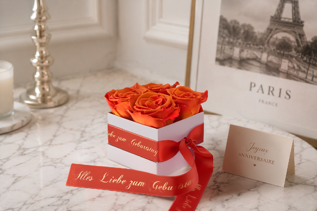 Orange preserved roses in an elegant gift box with personalised birthday ribbon and card
