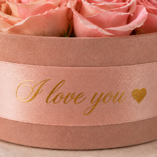 Personalised satin ribbon on a pink preserved rose box with gold I love you lettering
